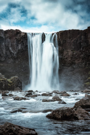 Dramatic scenery of Gufufoss waterfall flowing on summer in east fjords at Seydisfjordur, Icelandの写真素材