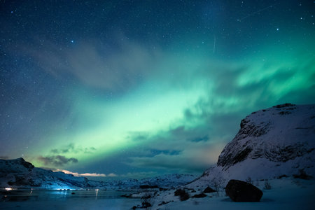 Beautiful landscape of Aurora borealis, Northern lights glowing over snowy mountain on arctic ocean...