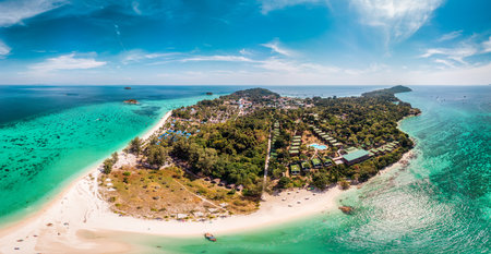 Aerial view of beautiful vibrant tropical sea of Lipe Island with coral reef and traditional boat by the beach in summer at Satun, Thailandの写真素材