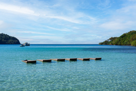 Empty sun lounger floating on turquoise sea in bright dayの写真素材