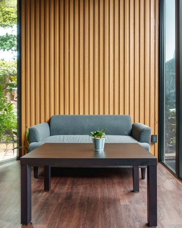Interior contemporary design of tropical living room with cushion sofa, plant on the table, wooden wall and tropical gardenの写真素材