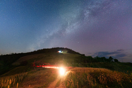Scenic view of Milky way with starry over mountain and corn field on hill in the night at Chiang Mai, Thailandの写真素材