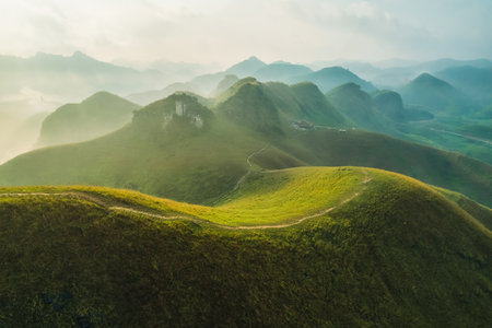 Aerial view of Beautiful Ba Guang grass hill, Mountain range with fog on the mountain in the morning at Ha Lang, Cao Bang, Vietnamの写真素材