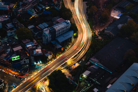 Aerial view of light on expressway passing crowded downtown during dawn at Bangkok, Thailand