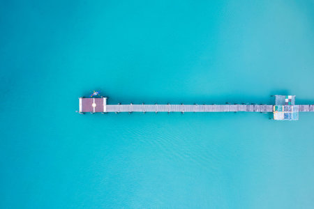 Top view of tourist canoeing by wooden pier in turquoise sea on summer at tropical island. Leisure...