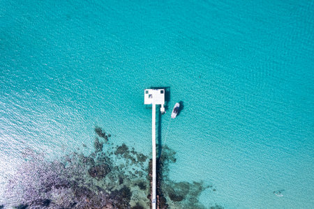 Aerial view of Beautiful crystal turquoise sea and wooden pier, boat on coastline in sunny day at Koh Kood Island, Trat, Thailandの写真素材