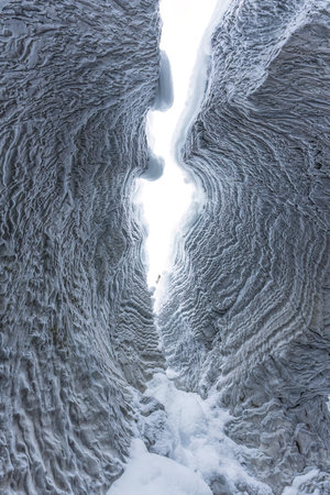 Beautiful Ice cave with rock formation of water eroded on winter at Natural bridge, Yoho national park, BC, Canadaの写真素材