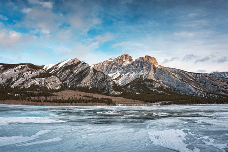 Landscape of Rocky mountains on frozen lake in Abraham Lake at Kootenay plains area, Canada
