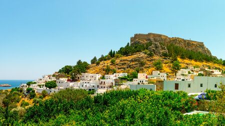 The historic city of Lindos and the Acropolis of Lindos in beautiful blue sky on Rhodes, Greeceの写真素材