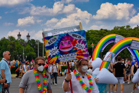 Berlin, Germany - July 24, 2021 - Participant at the Christopher Street Day (CSD) demo in Berlin with a sign (german) KÃ¼ss mich, Ich bin anders ("Kiss me, I'm different")のeditorial素材