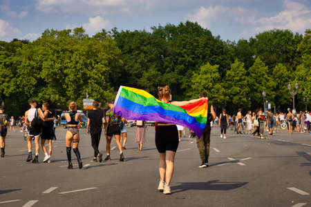 Berlin, Germany - July 24, 2021 - A woman wears a rainbow flag on Christopher Street Day (CSD) in Berlinのeditorial素材