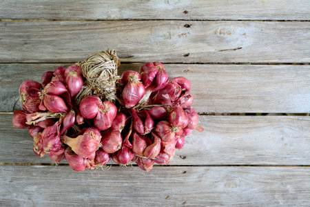 Red Onion on wood background (Allium Ascalonicum).