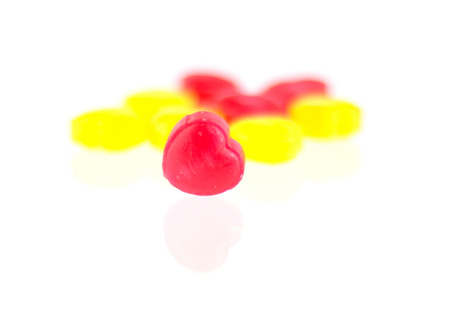 Red and yellow candy hearts isolated on white backgroundの写真素材