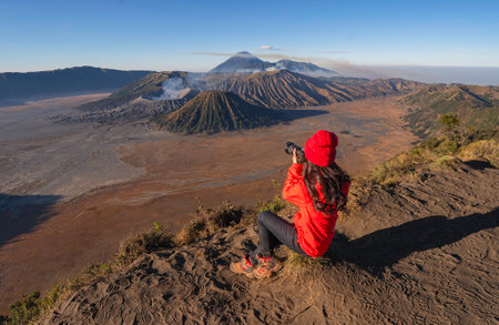 Travelers relax and enjoy the morning scenery at Mount Bromo. Located in Bromo, Tengger, Semeru National Park, East Java, Indonesia.の写真素材