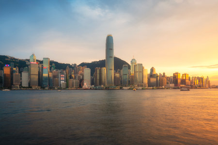 Hong Kong skyline at sunset over Victoria Harbour, one of the most popular tourist attractions on Hong Kong Island, China.の写真素材