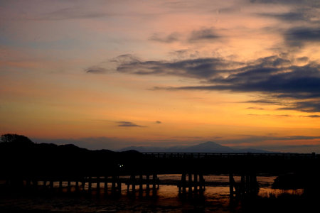 Silhouette of the bridge over the river in the evening.の写真素材