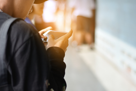 People are using a mobile phone to buy a product. And contact friends online.People use mobile phones to make purchases online.の写真素材