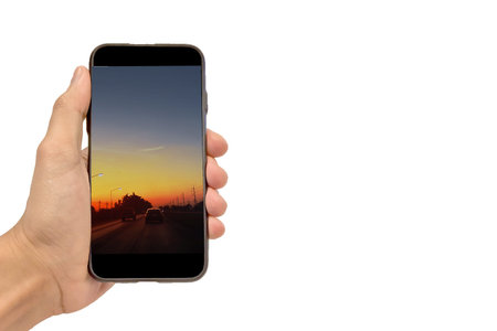 Hand holding smartphone on white backgroundの写真素材