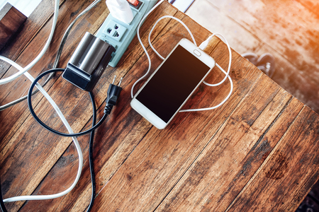 Smart phone on wooden table copy spec for texture concept or design,Vintage style and Summer holiday conceptの写真素材