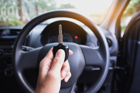 Key on hand in car for driving a car on roadの写真素材