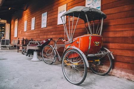 Ancient Tricycle against wooden background vintage styleの写真素材