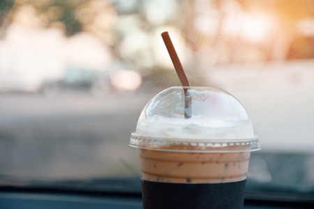 cool coffee in car parked on road for drink before driveの写真素材