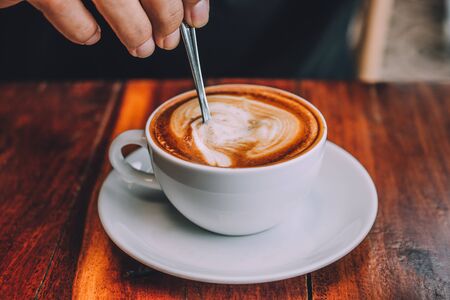 Coffee milk latte on wood table at coffee shop for drink in coffee timeの写真素材