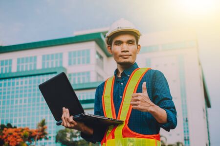 Engineer holding computer working on side technologyの写真素材