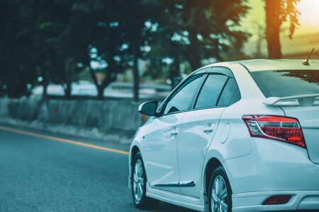 Car parked on road and Small passenger car seat on the road used for daily tripsの写真素材