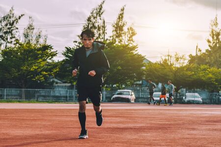 Runner Man jogging or running in evening at sunlightの写真素材