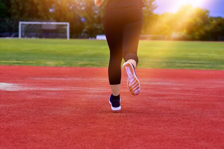 Runner Women jogging or running in evening at sunlight,Lady run jogging or exercise,Woman Runner or Girl Runningの写真素材