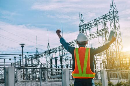 Engine Currently holding a tablet and a power plant with the Electricity Authorityの写真素材