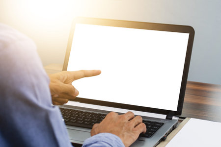 Hand pointing focus on computer in workspace office