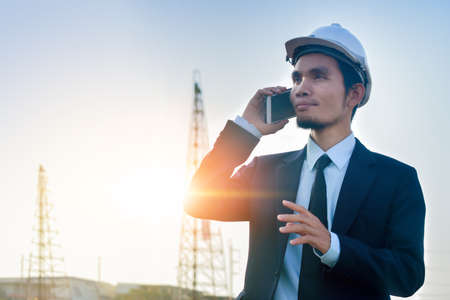 Manager call phone outdoor work architect building backgroundの写真素材