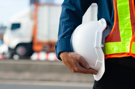 Close up Engineering holding white helmet hard hat safety and Road construction background