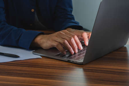 Man using computer in office , Hand typing on keyboard search online internetの写真素材
