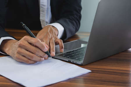 Closeup hand manager signature on document, Sign contact business in office conceptの写真素材