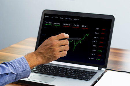 Man point on screen digital chart trading online at home