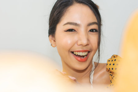 Portrait Woman happy with  bread in bread shop, Women holding bread smile in bakery shopの写真素材