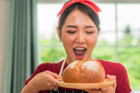 Portrait Woman breaking fresh bread closeup