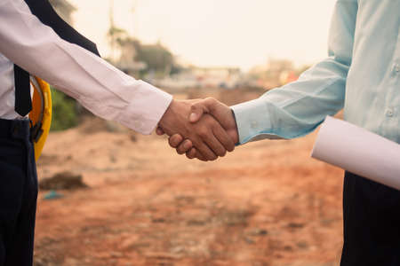 Businessman Shake hand agreement construction real estate project on siteの写真素材