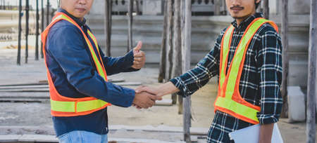 Teamwork Engineer shake hand on site construction backgroundの写真素材