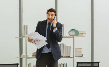 Businessman call cellphone in officeの写真素材