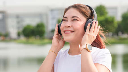 Asian women Happy listening music outdoorの写真素材