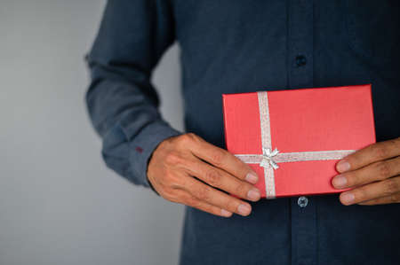 Hand holding gift box, new year gift box, Christmas gift box ,copy space. Christmas, hew year, birthday concept.の写真素材
