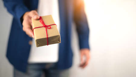 Closeup hand holding gift box, new year gift box, Christmas gift box ,copy space. Christmas, hew year, birthday concept.の写真素材