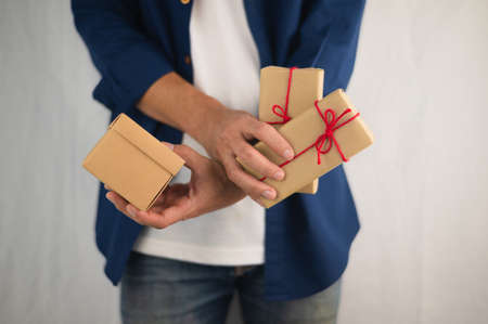 Closeup hand holding gift box, new year gift box, Christmas gift box ,copy space. Christmas, hew year, birthday concept.の写真素材
