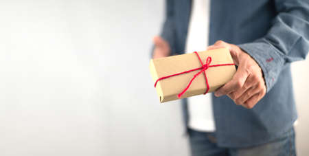 Closeup hand holding gift box, new year gift box, Christmas gift box ,copy space. Christmas, hew year, birthday concept.の写真素材
