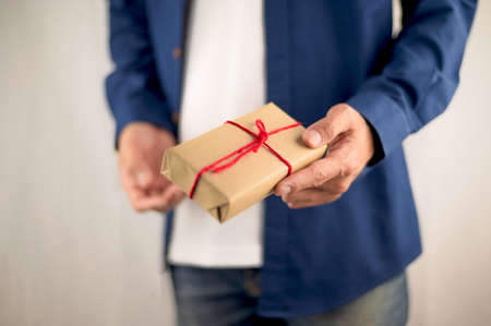 Hand holding gift box, new year gift box, Christmas gift box ,copy space. Christmas, hew year, birthday concept.の写真素材