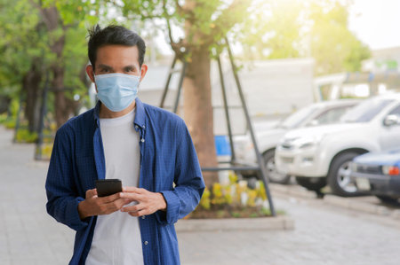Man wear face mask using mobile smartphone